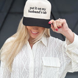 Put It On My Husbands Tab Trucker Hat - Infinity Raine